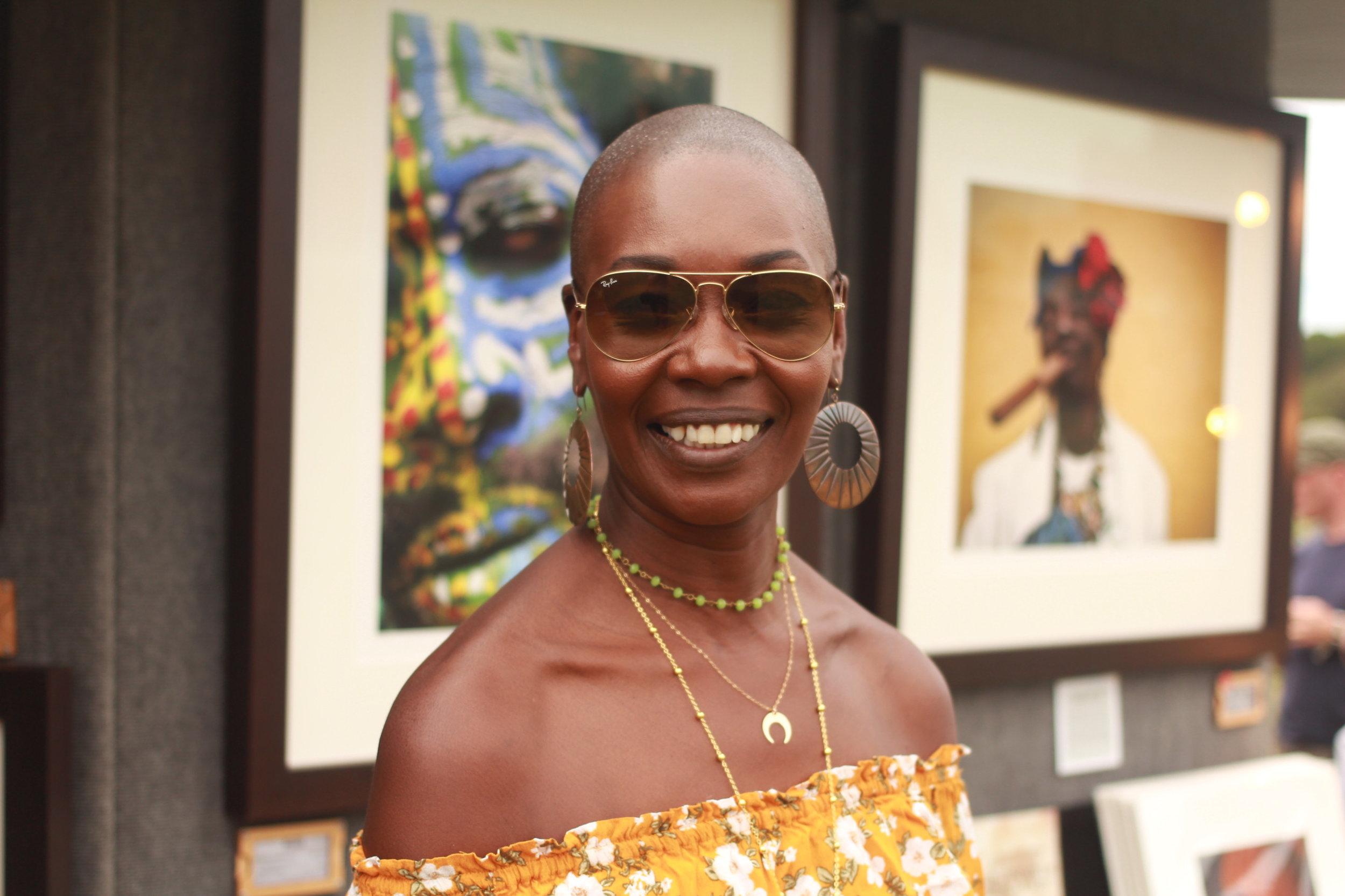   A festivalgoer stands among some of the local artwork.&nbsp;  