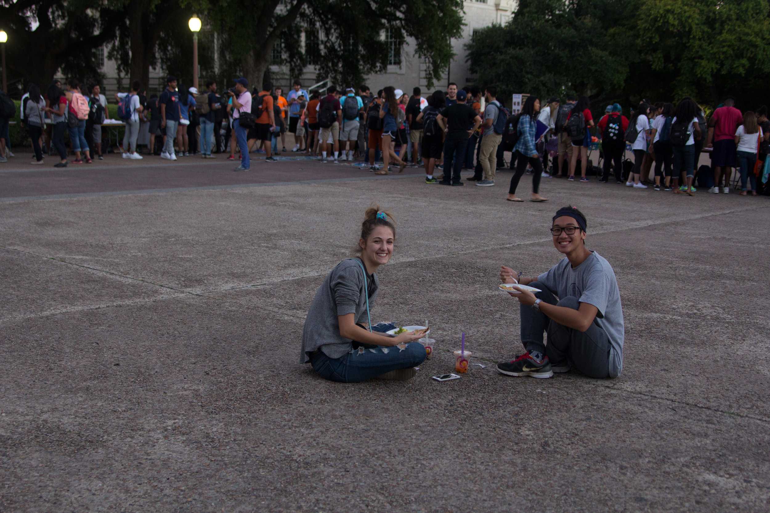   Students Jamie Abraham and Elijah Sy enjoyed their food after visiting the different tables.  