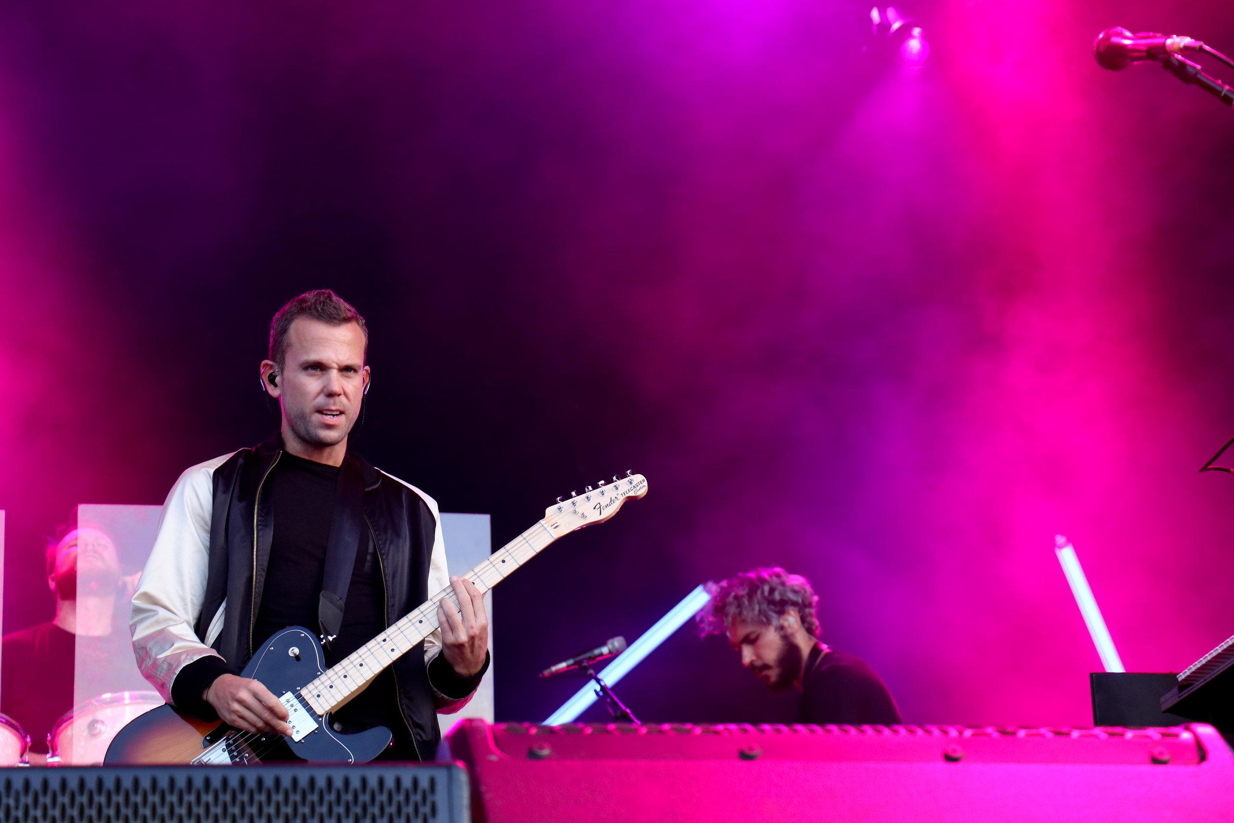   Frontman of M83 stares into the field of fans.  