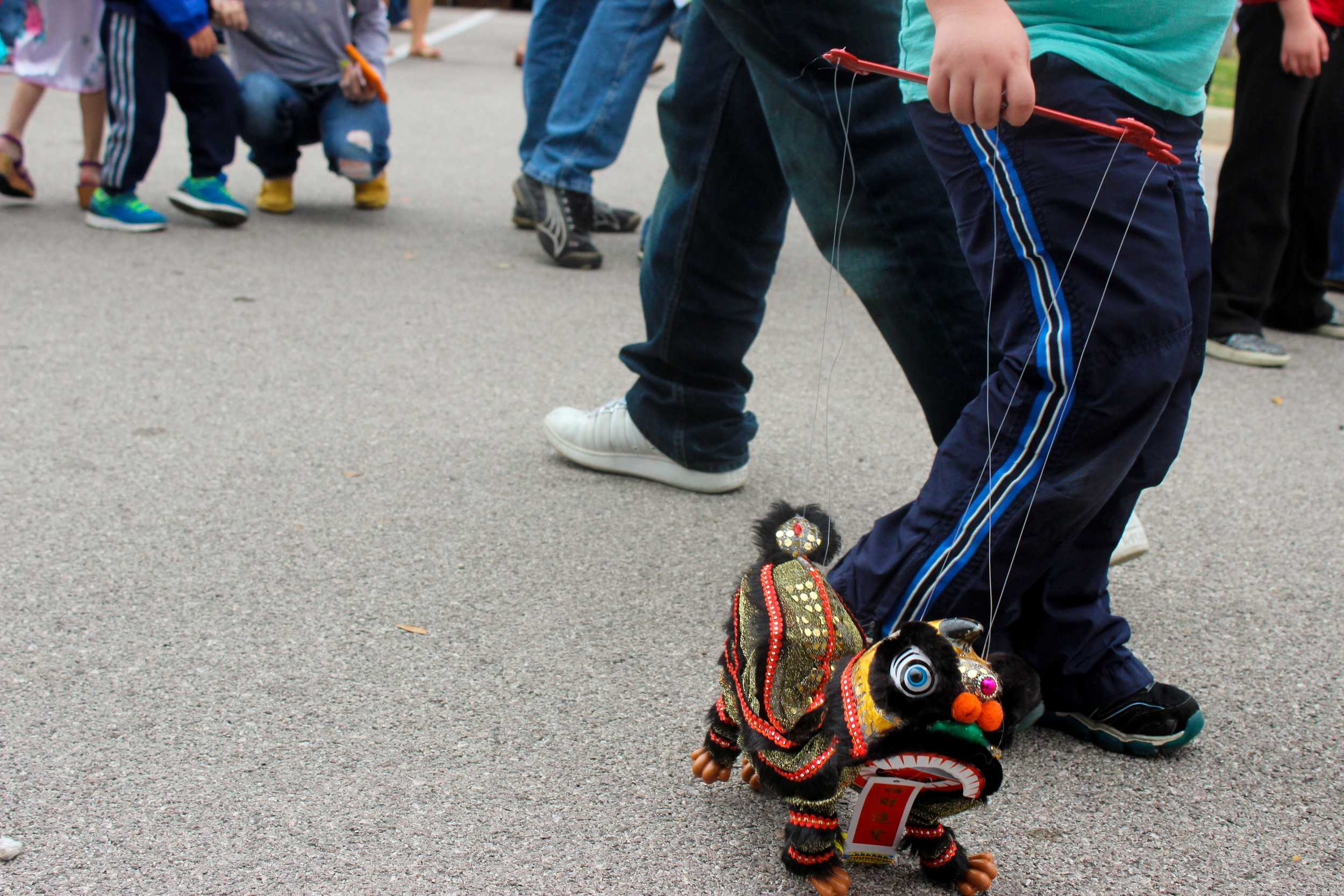  A little boy walks a Chinese dragon puppet alongside him throughout the festival. 