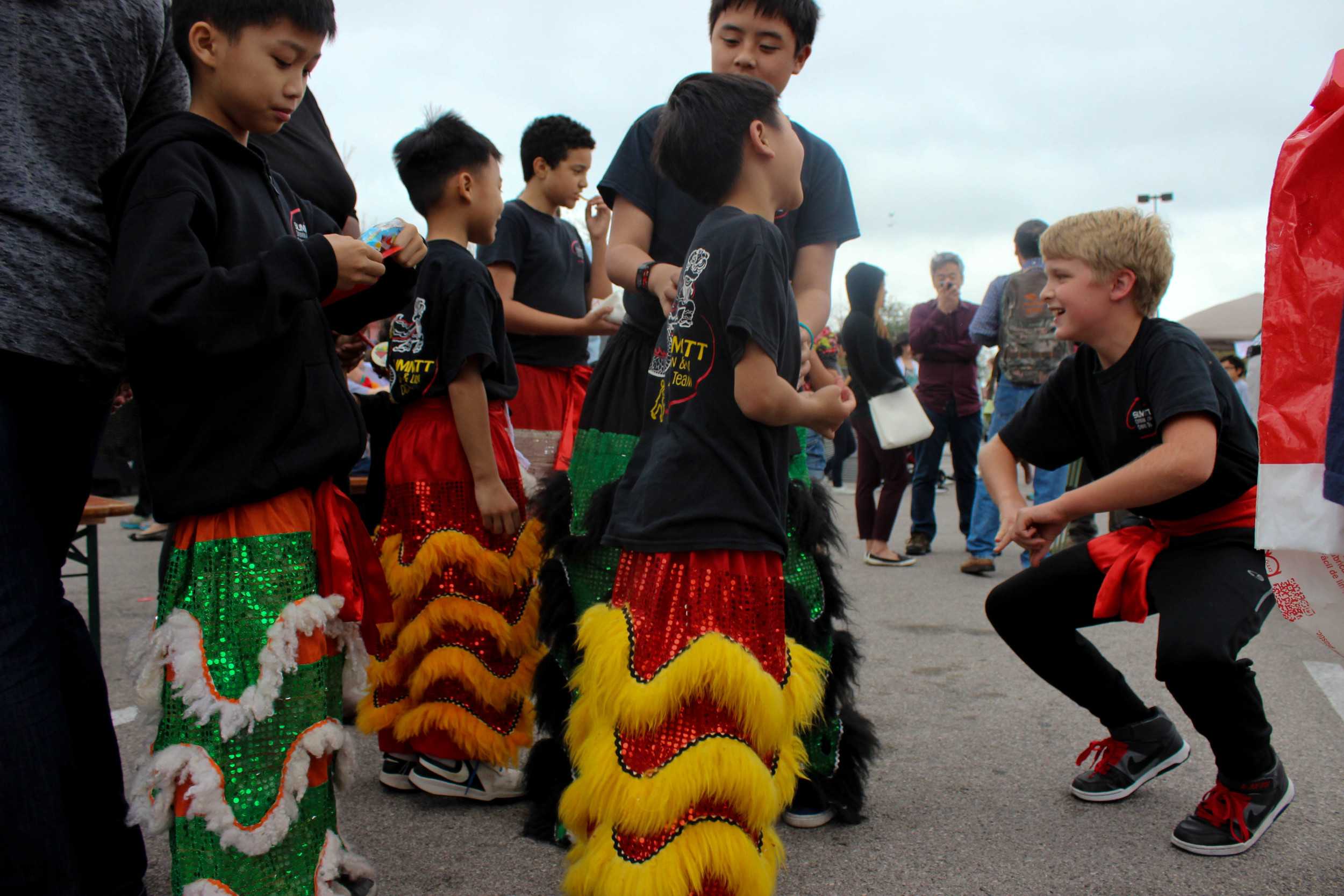  These boys' bright smiles and colorful pants brighten up this cloudy Saturday. 