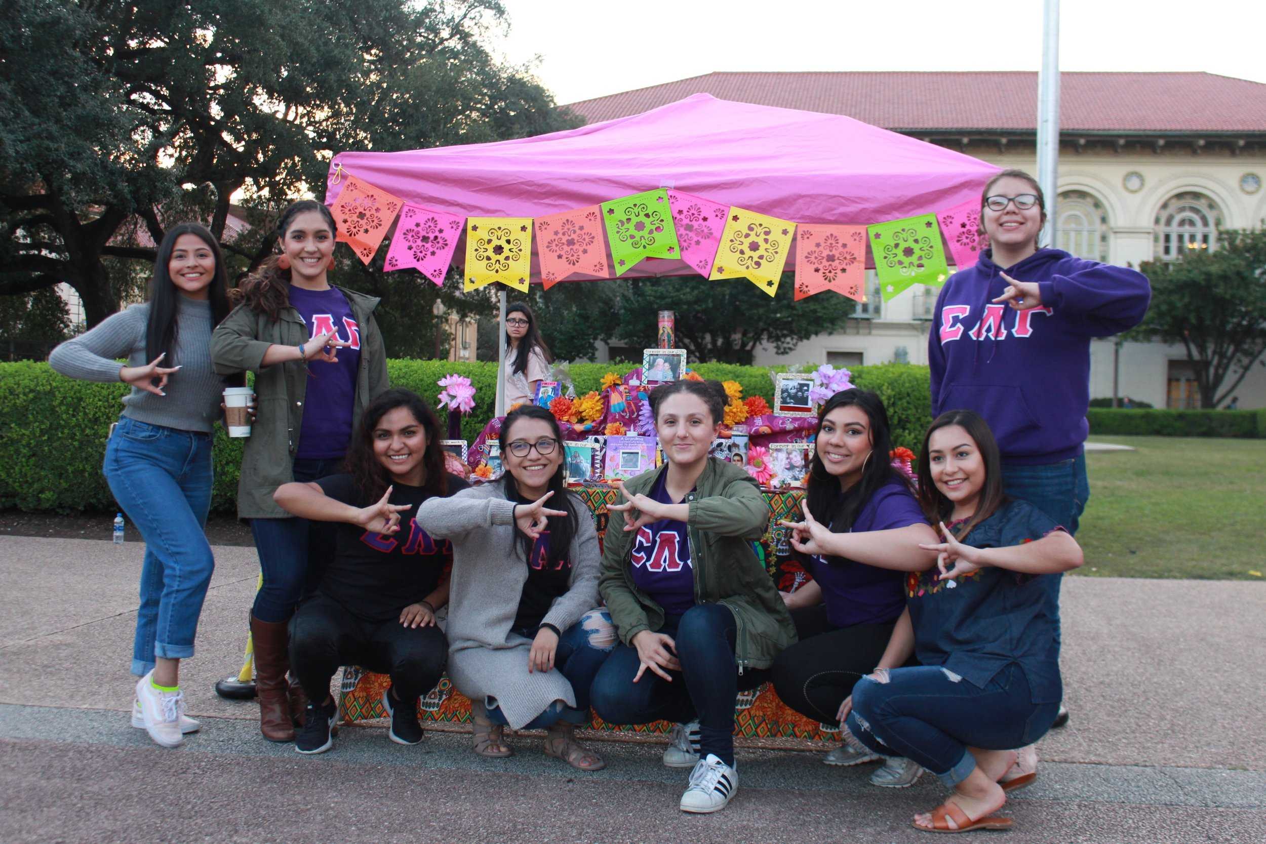  The women of Sigma Lambda Gamma proudly represent their name and their altar that is full of symbolism. From the colorful paper reminding viewers of the fragility of life, to the marigold's sweet scent which guide the dead towards the altar. 