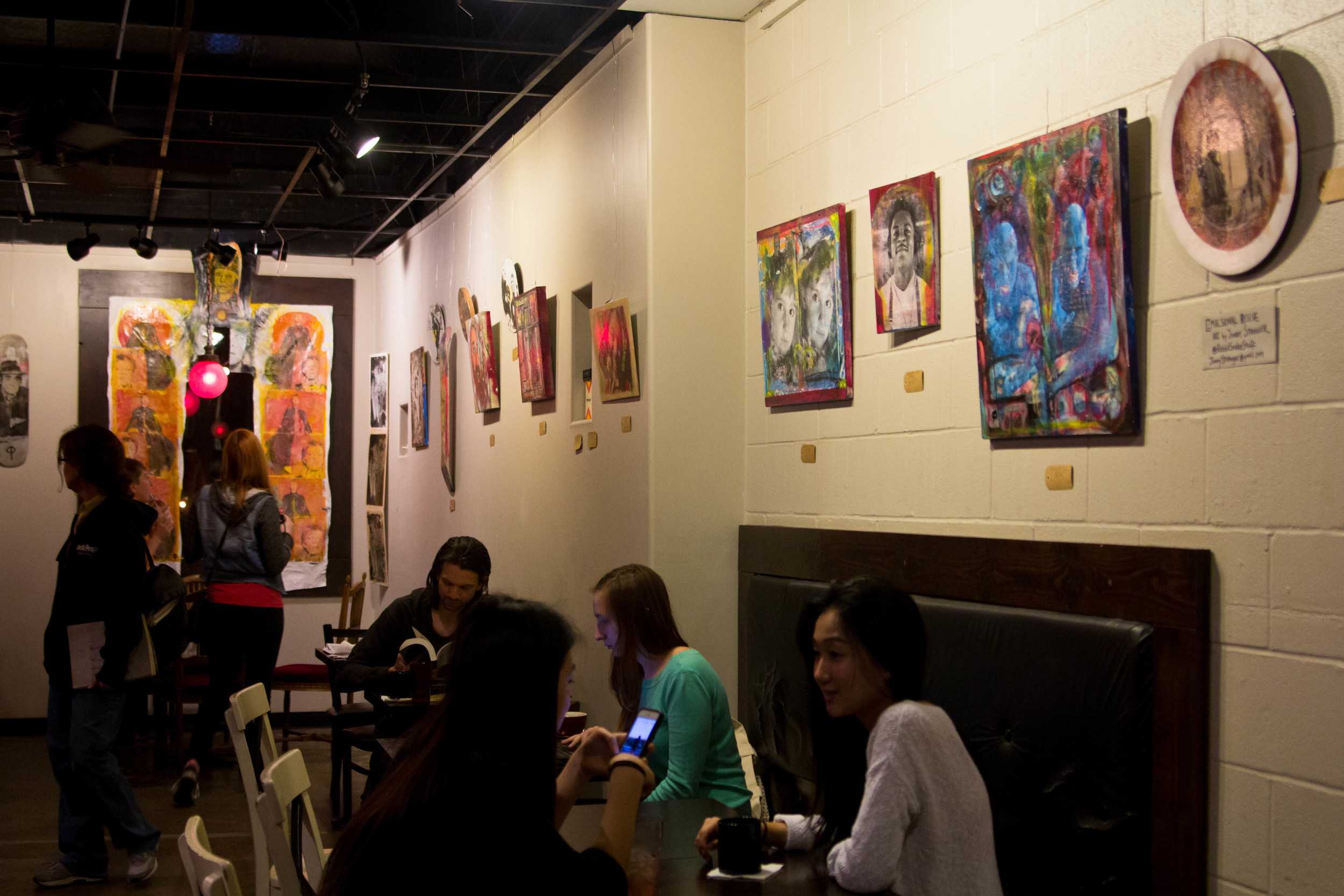  Patrons enjoying coffee and art at Once Over Coffee Bar. 