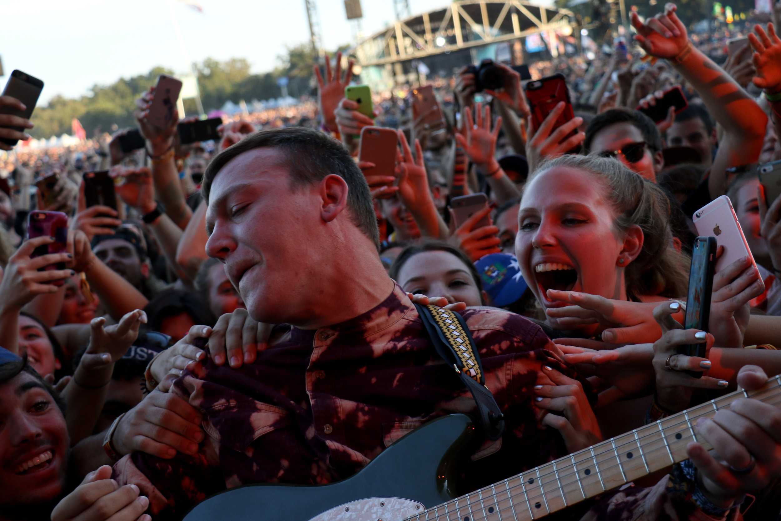   Brad Shultz of Cage The Elephant takes his guitar out to play with the fans.  