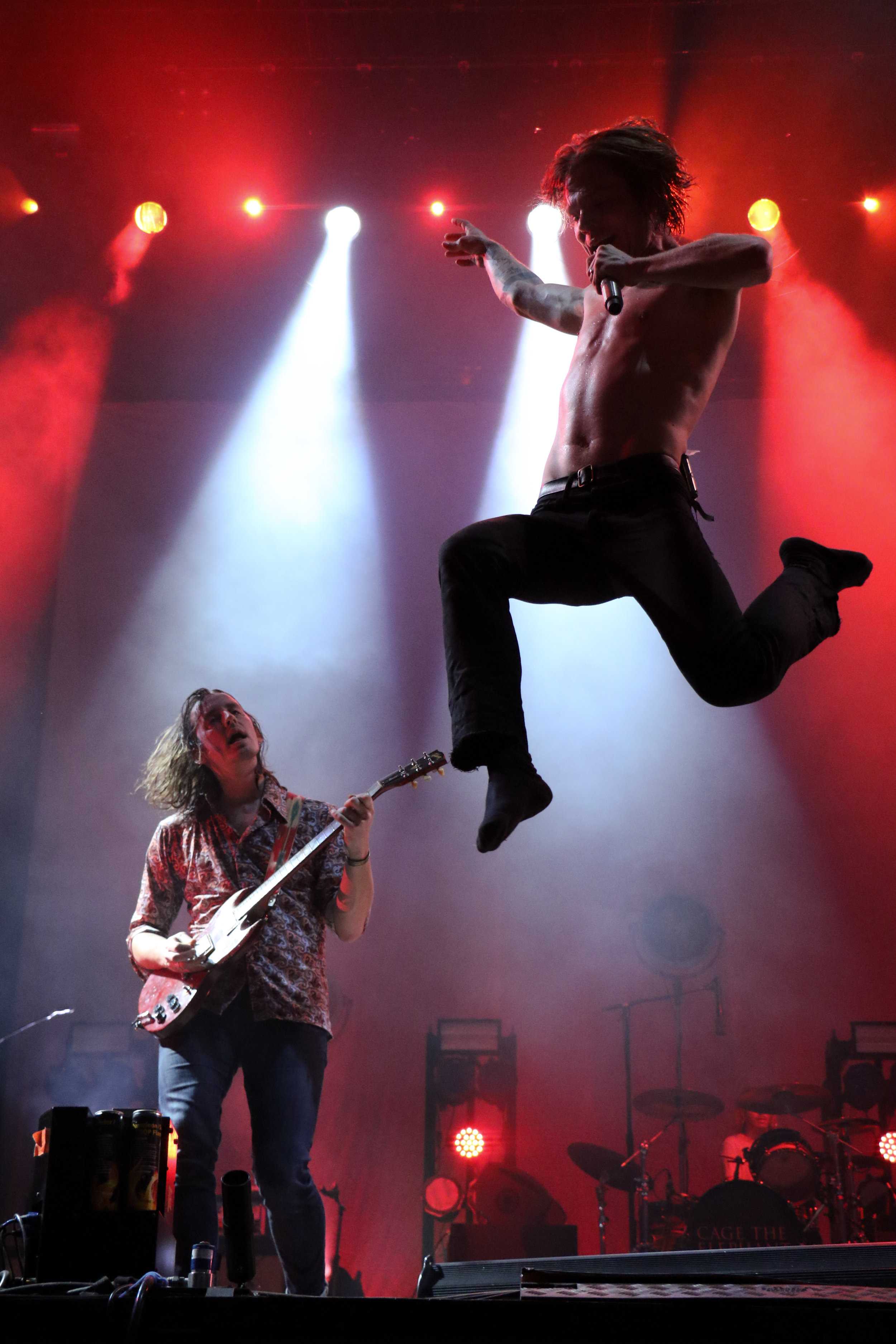   Matt Shultz, frontman of Cage The Elephant, takes a leap off stage.  