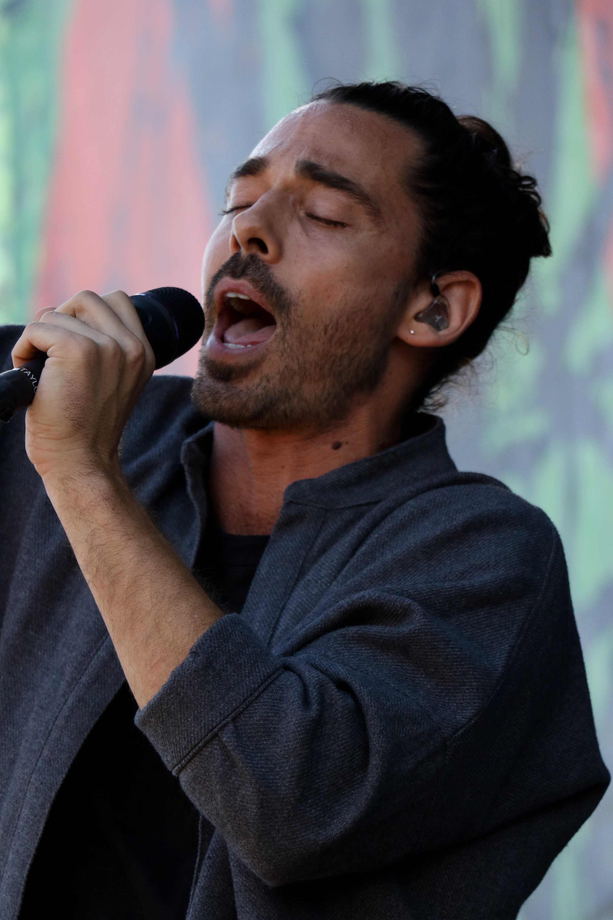   Taylor Rice, frontman of Local Natives, sings for Day 3 festival-goers.  