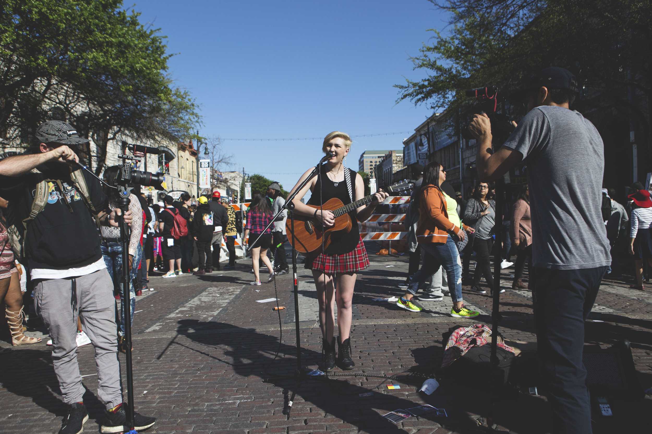  Street musicians busque on Sixth Street on March 19. 