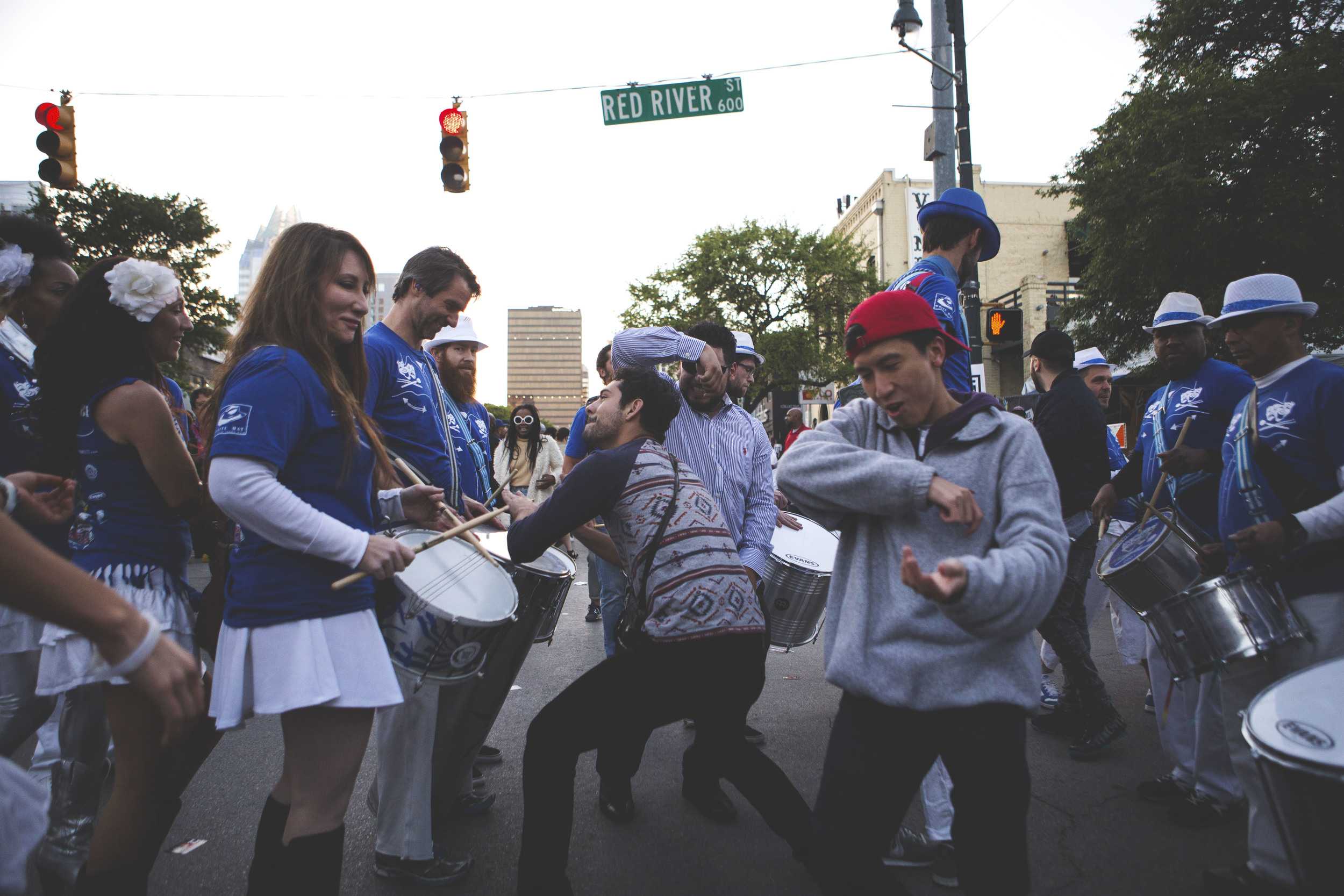  SXSW attendees dance with street performers on the corner of Sixth and Red River on March 19. 