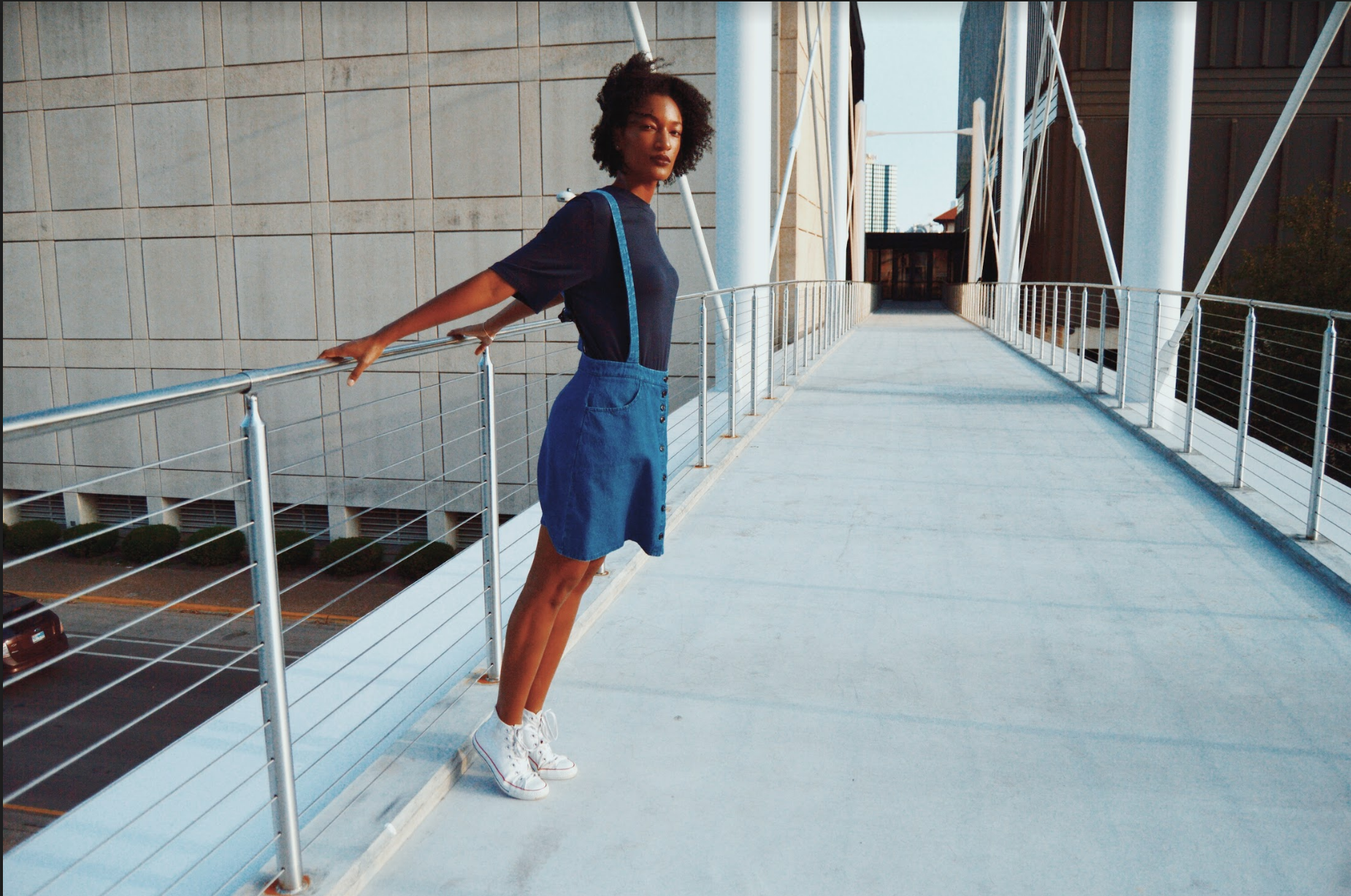    Griffith rocks a pair of dark blue denim overalls by Loup and a navy blue T-shirt by The Fifth Label. Shoes pictured are model’s own.    